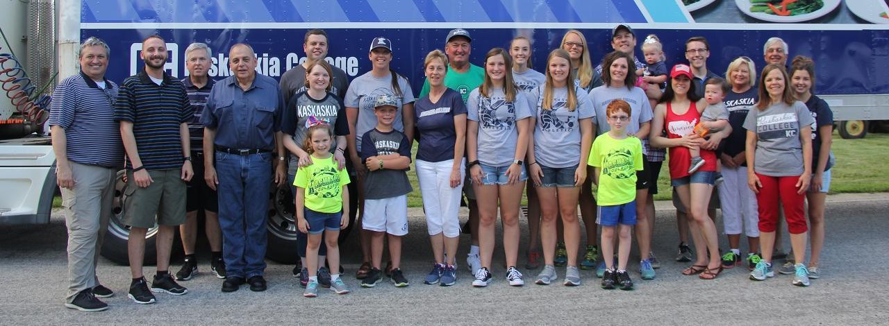 Kaskaskia College staff, faculty and students standing in front of a college tractor trailer prior to Albers 4th of July parade.