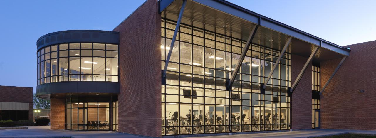 View of KC Fitness Center from outside at night.