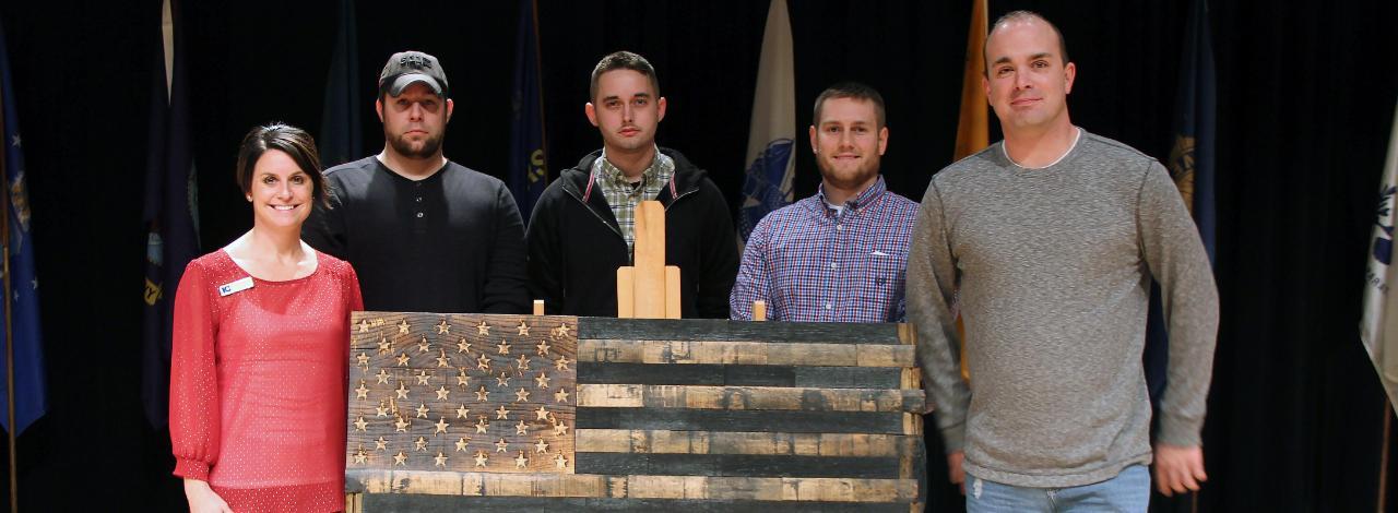 Students with wooden American flag
